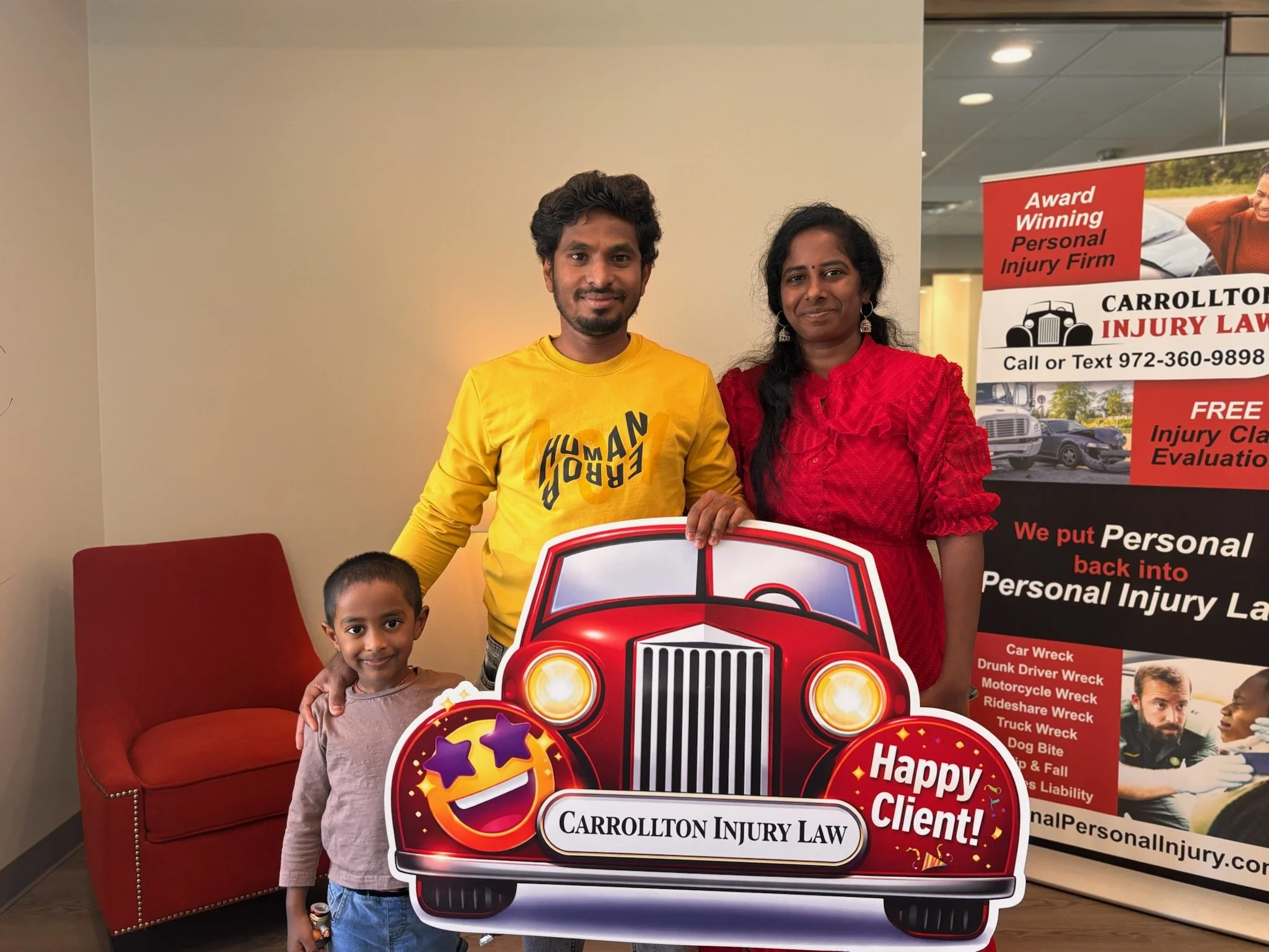 Smiling family holding a happy client sign