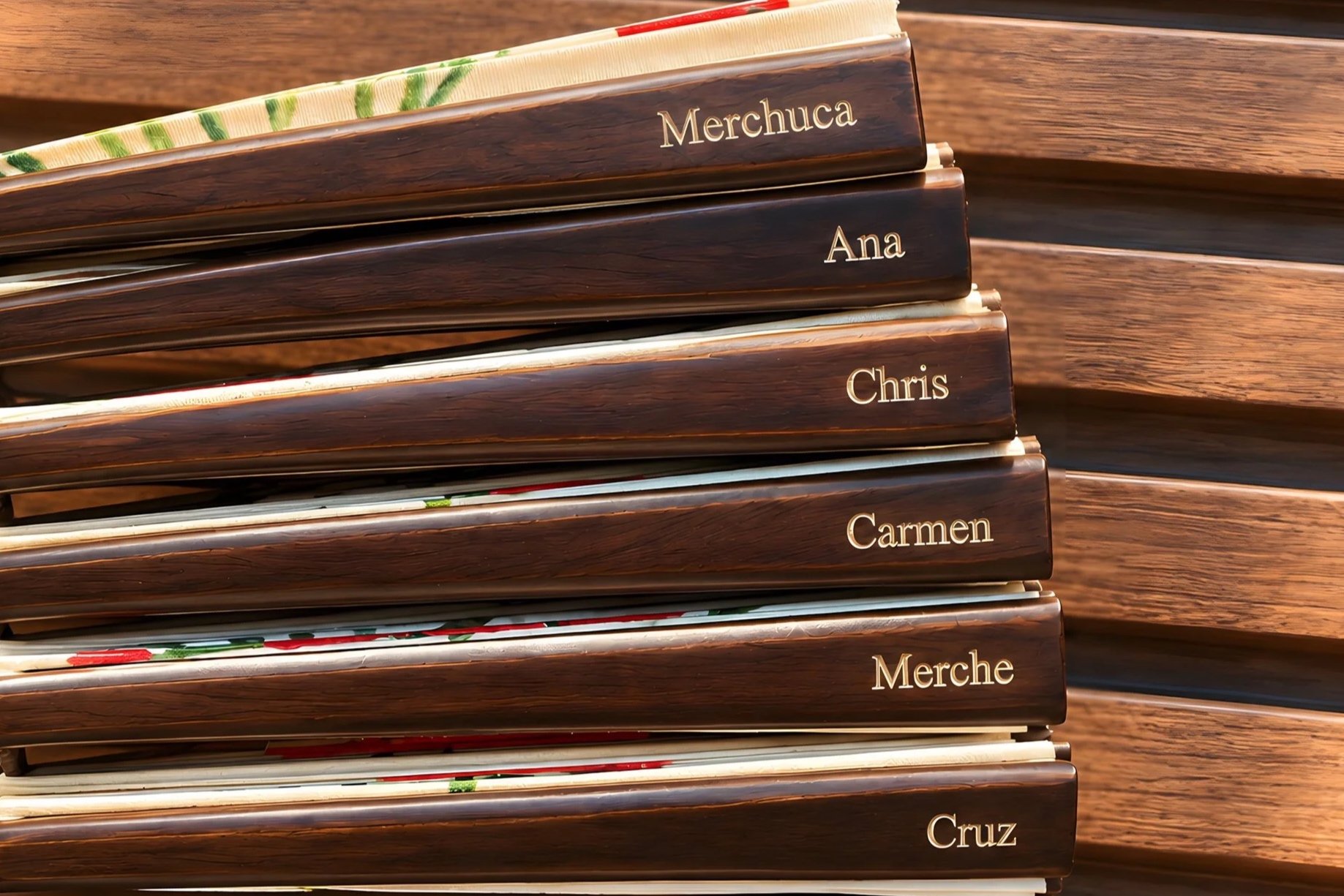 Luxury hand fans individually personalised with engraved names on a dark wood finish. An elegant option for events, weddings, VIP guests, brand activations and exclusive hotel guest experiences.