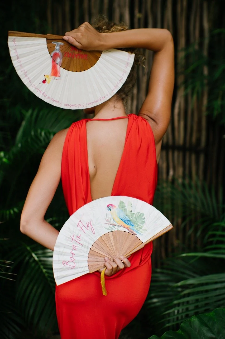 Bespoke illustrated hand fans created as distinctive accessories for hospitality, events and destination experiences.