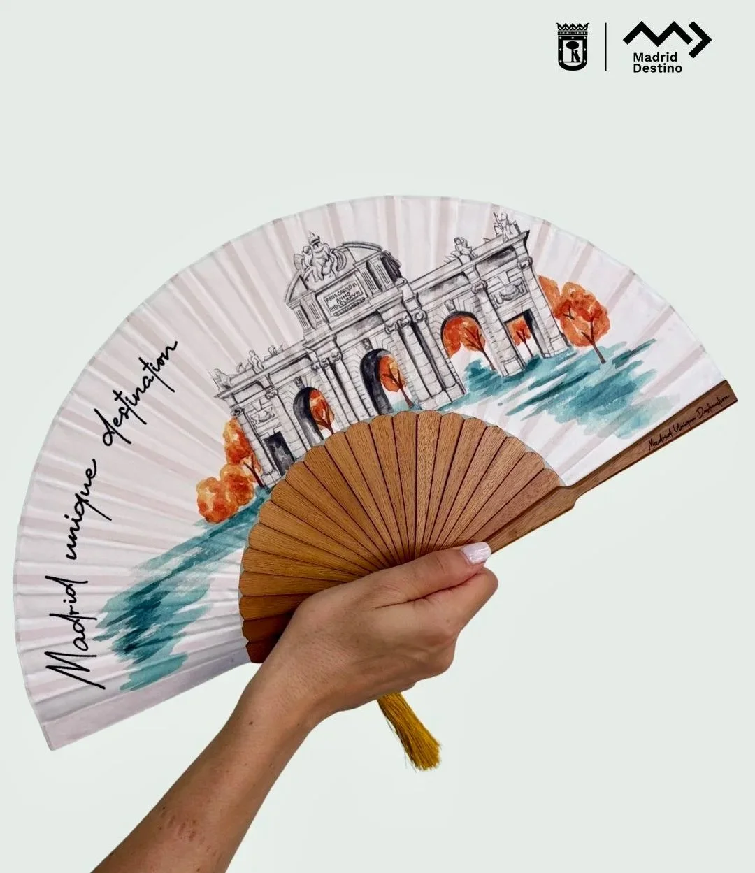 Each handcrafted fan features an exclusive watercolour illustration of Puerta de Alcalá, transforming Madrid's architectural heritage into a luxury keepsake for international guests.