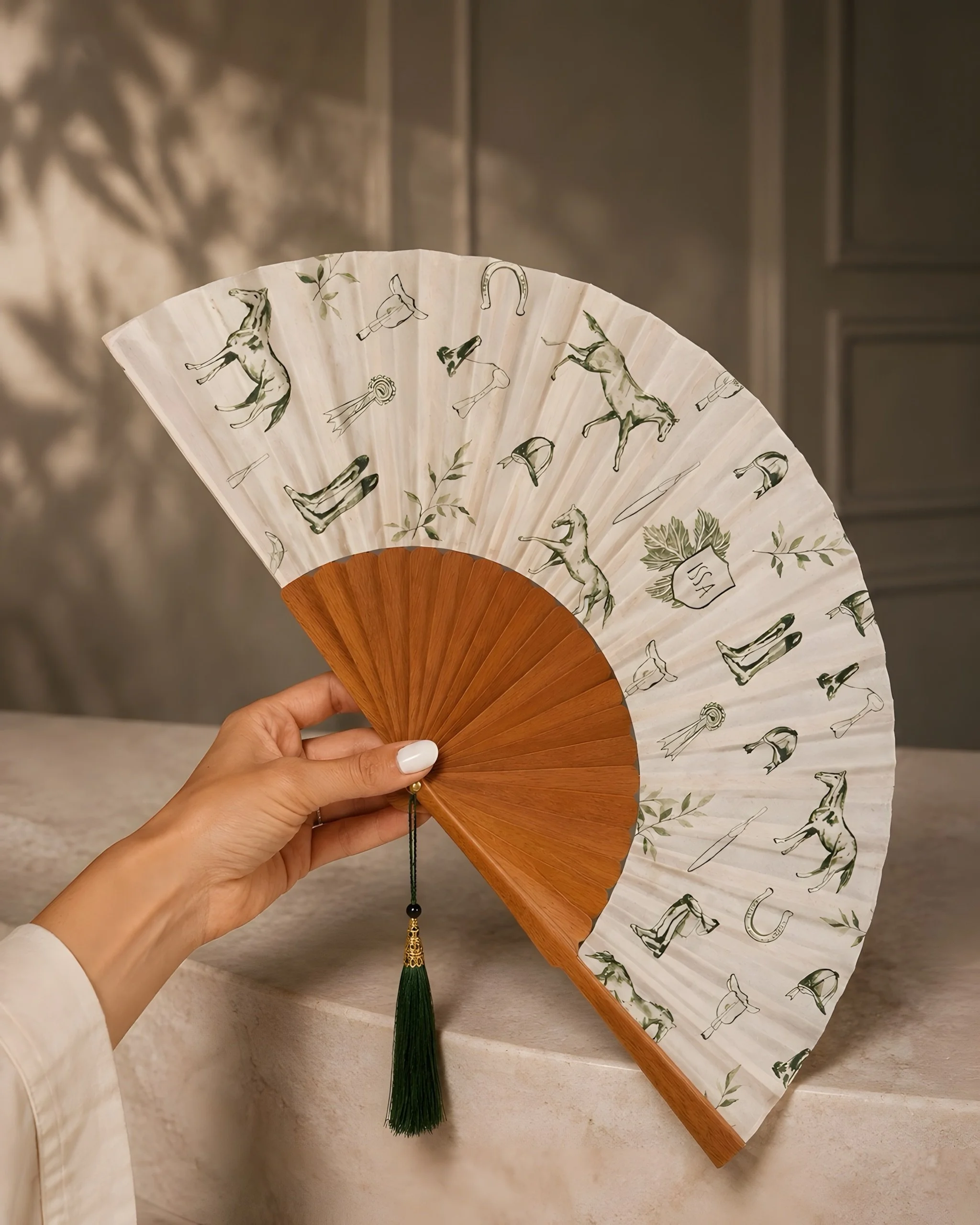 Bespoke luxury hand fan by Island Whisper Atelier, featuring original equestrian artwork created for a luxury hotel or resort guest experience.