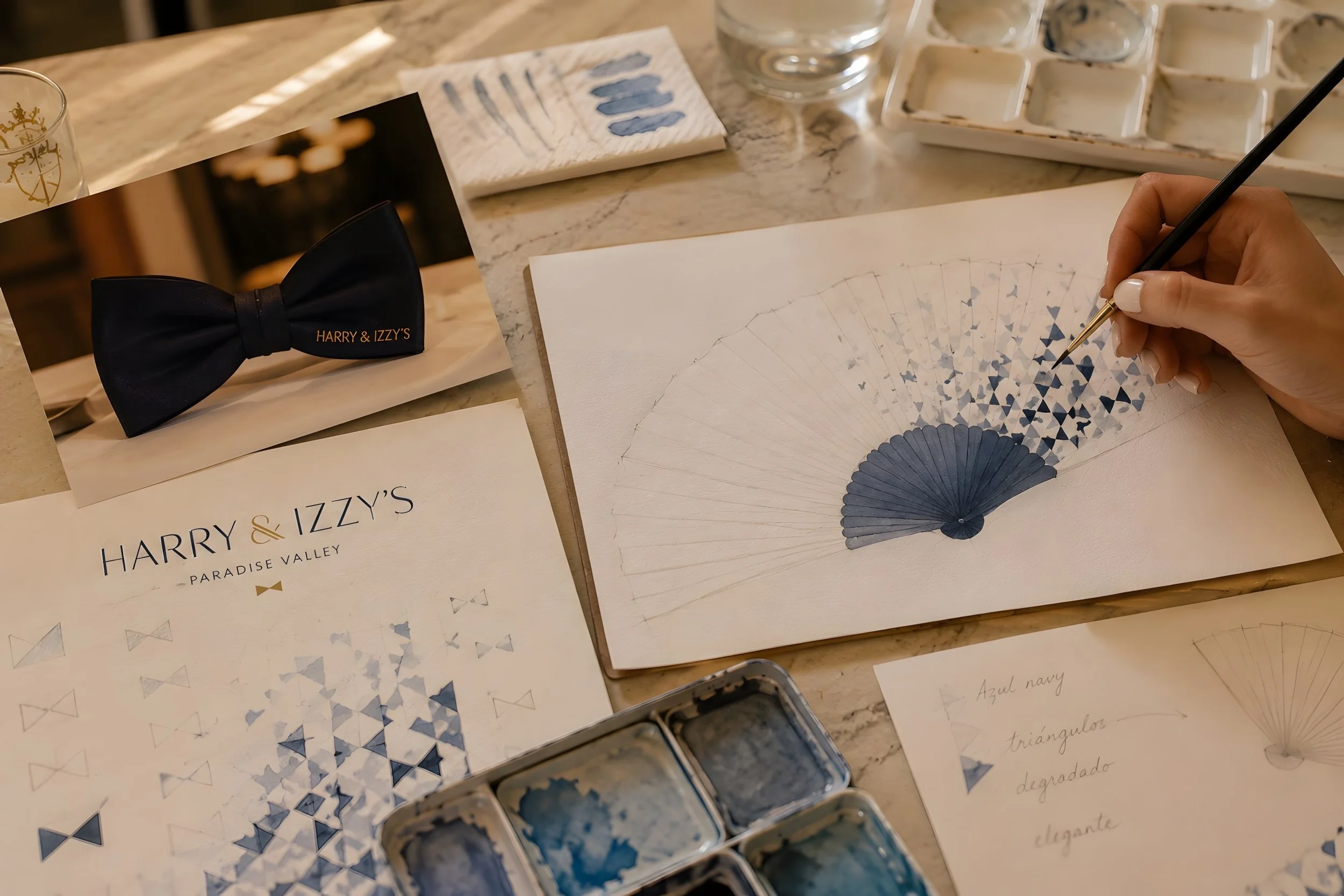 Creative process behind a bespoke hand fan by Island Whisper Atelier for Harry & Izzy’s, from original watercolor artwork and sketches to a distinctive guest experience piece.