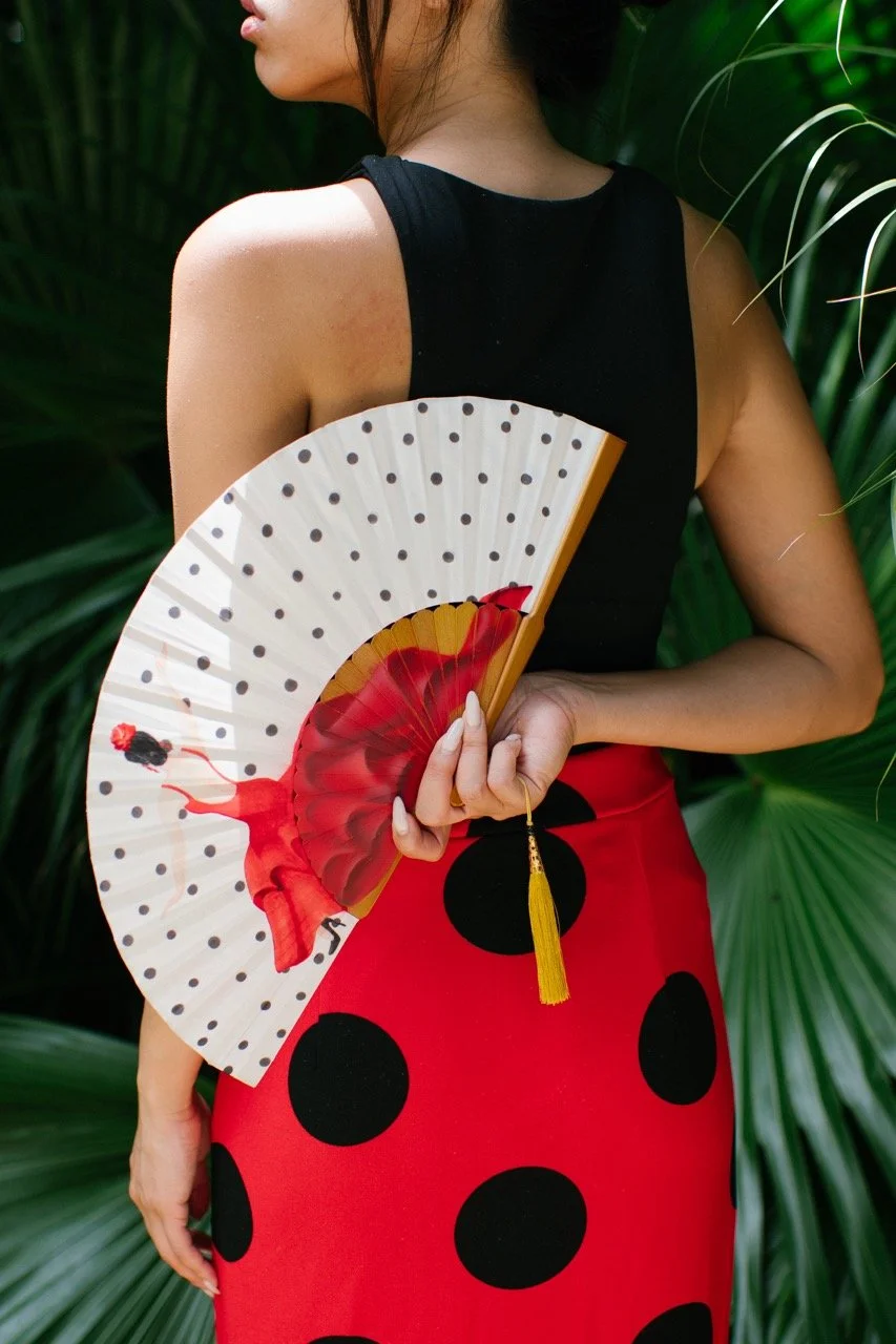 Contemporary bespoke hand fan with original red and white artwork, combining traditional fan craftsmanship with modern design.