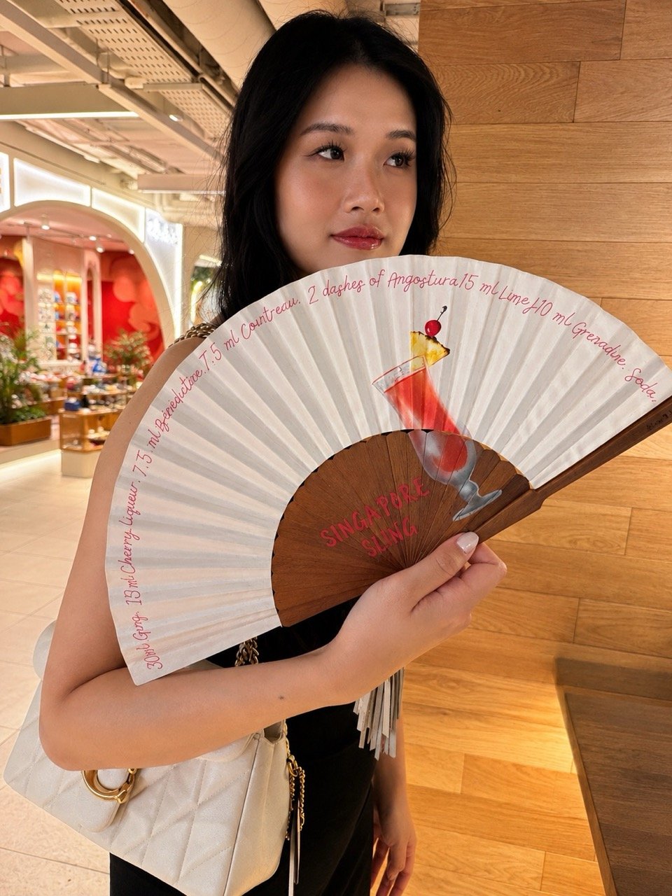 Bespoke Singapore Sling hand fan by Island Whisper Atelier featuring custom cocktail artwork, created for restaurants, hotels, hospitality brands and events in Singapore.