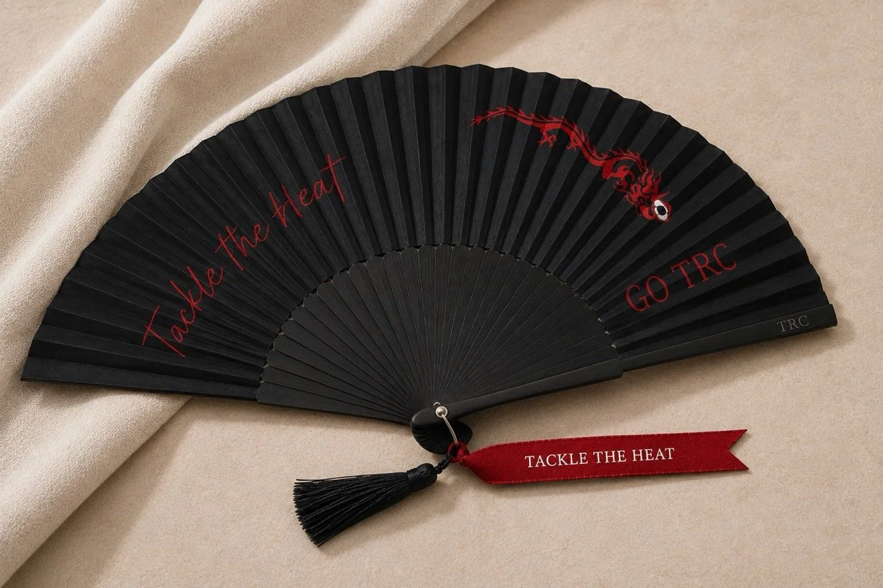 Tanglin Rugby Club luxury bespoke hand fan with original dragon artwork, TRC engraving and Tackle the Heat ribbon by Island Whisper Atelier.
