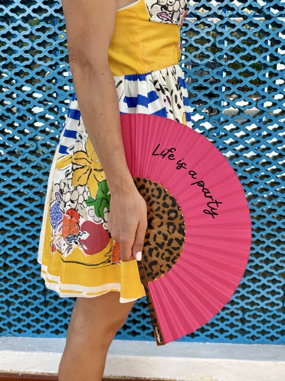 Bold pink bespoke hand fan with leopard detailing, demonstrating Island Whisper's playful approach to custom event and brand collections.
