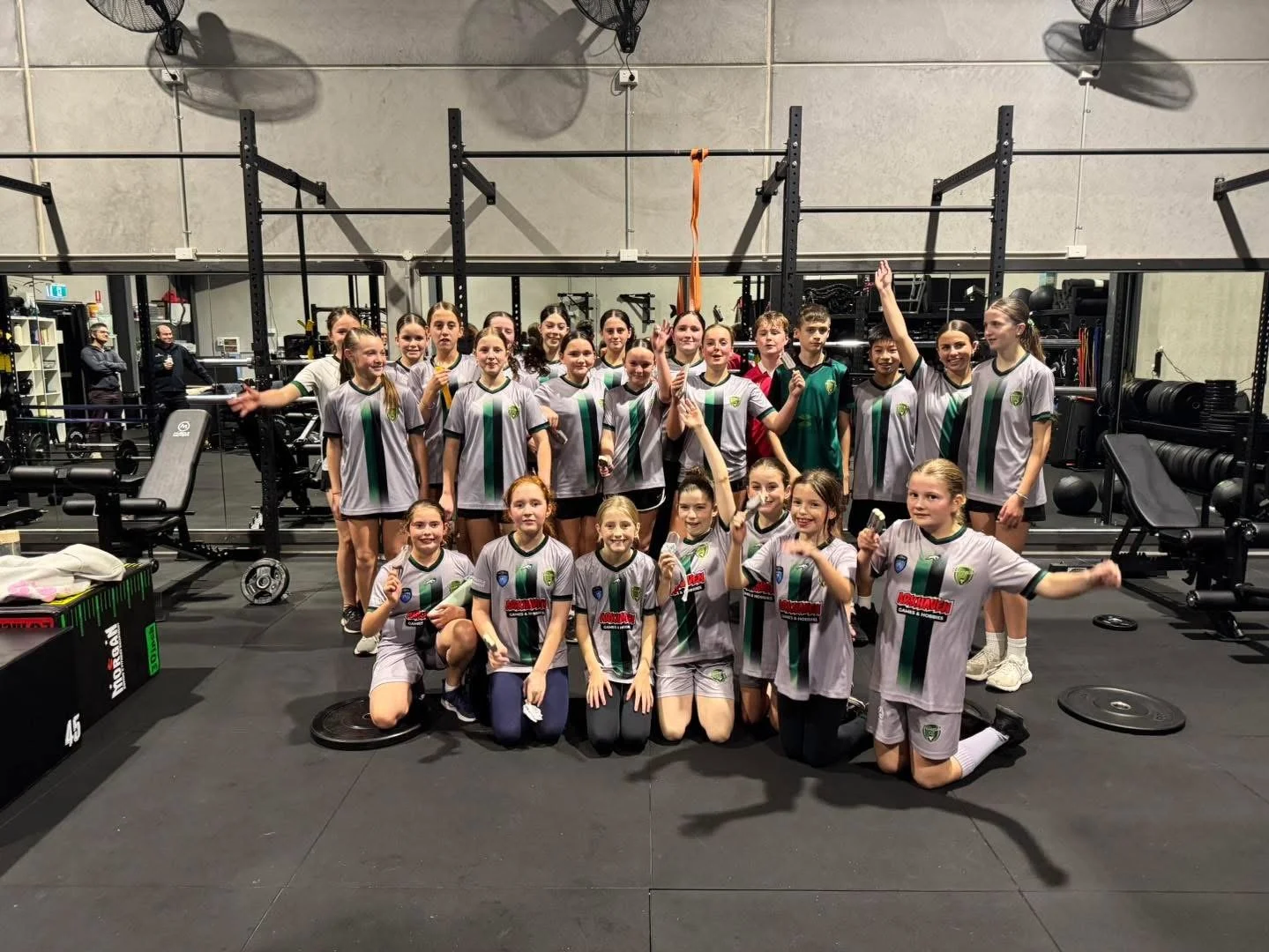 A group of girls in a sports team having just done a workout