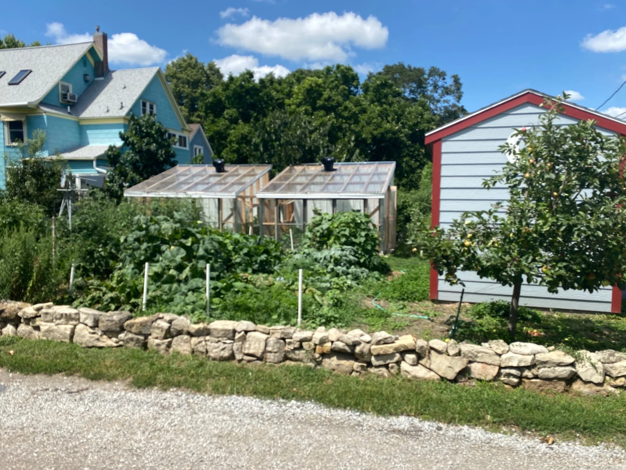 A good look at the stone border wall which protects gardens from trash trucks and a good look at some of the solar panels
