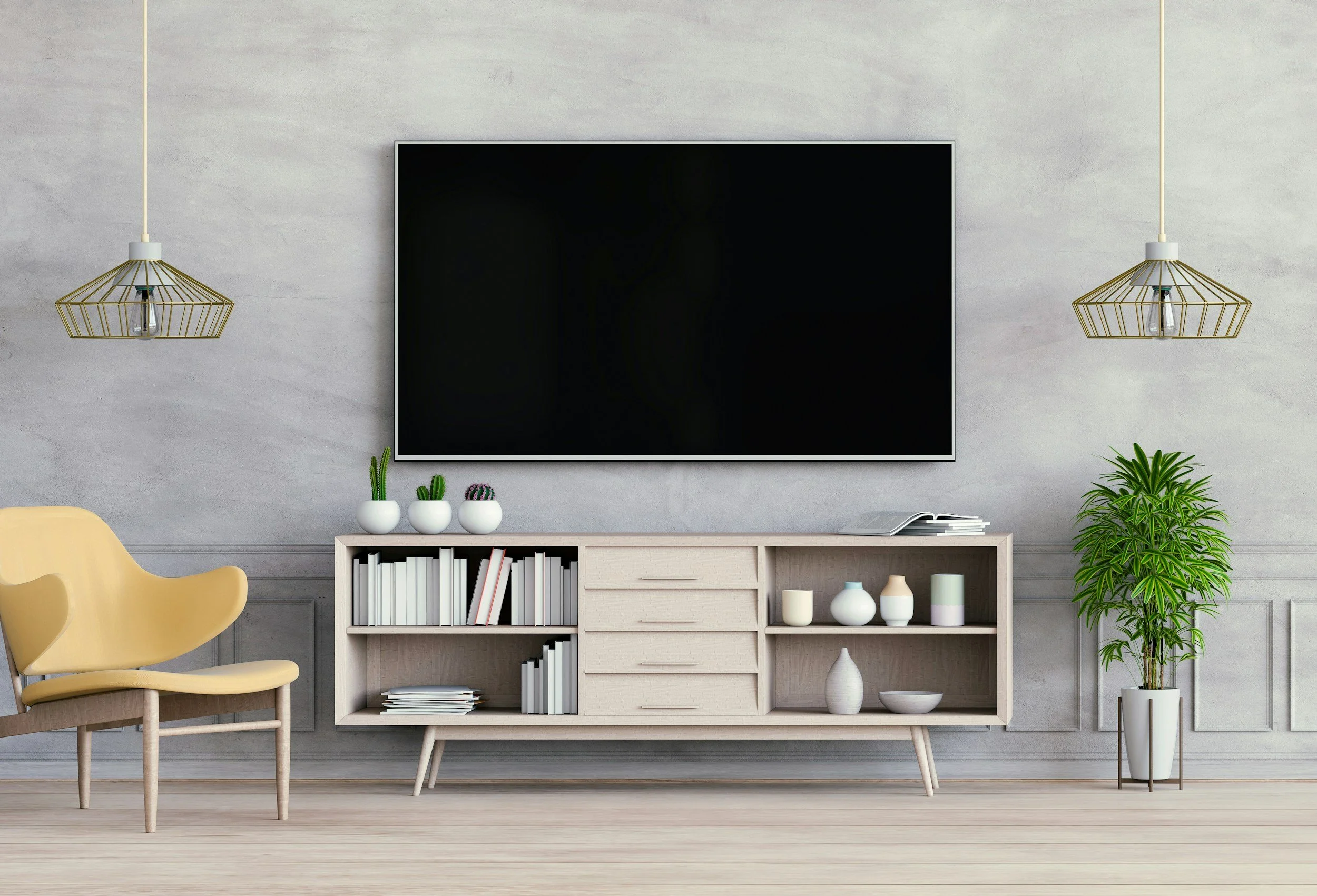 Modern living room with a wall-mounted flat-screen TV, white shelving unit with books and decorative vases, potted plants, two gold pendant lights, and a yellow chair.