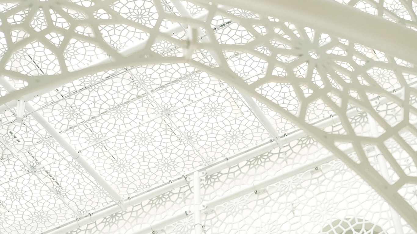 Close-up view of a white decorative lattice structure with intricate geometric patterns.