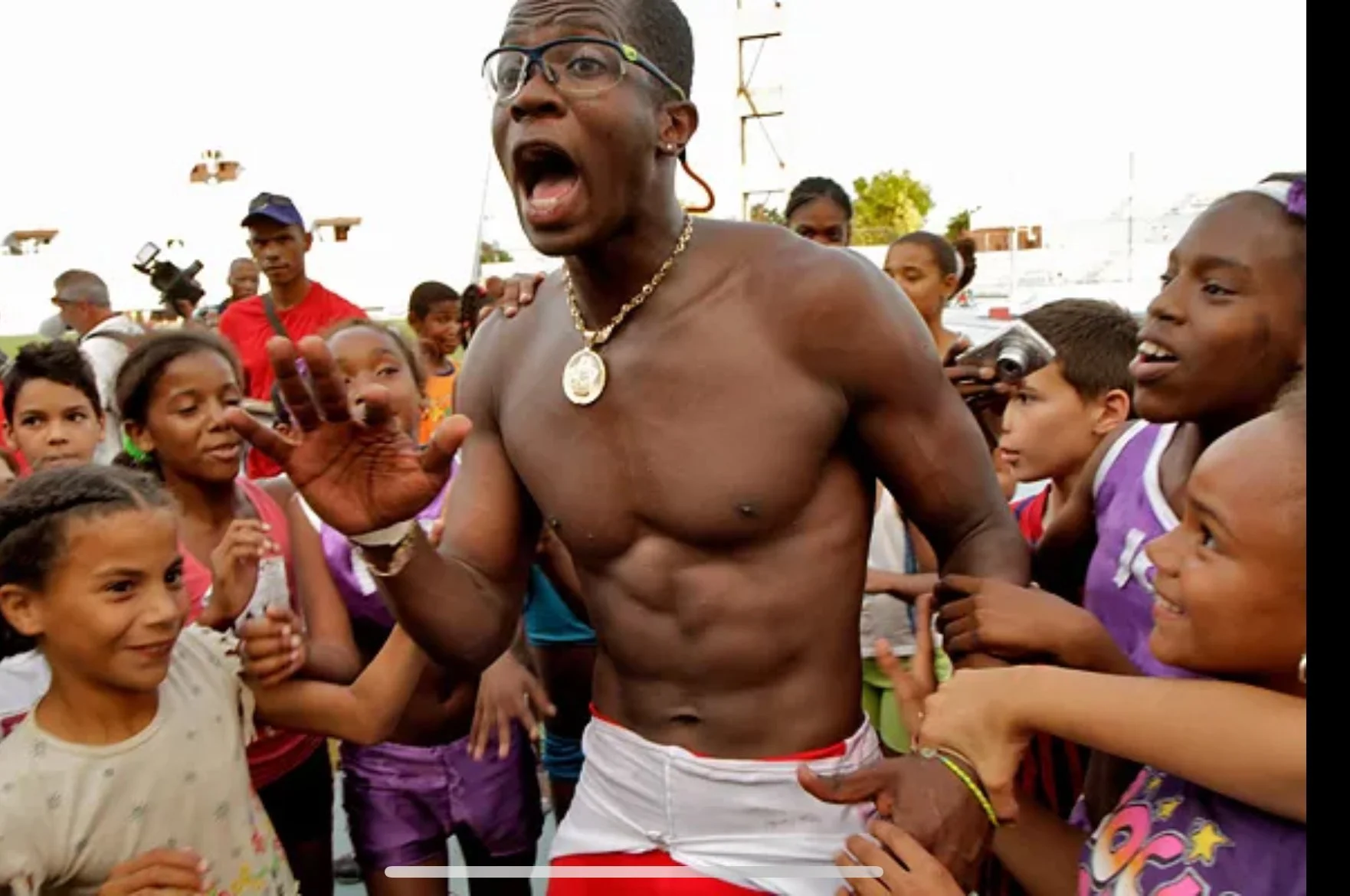 Dayron Robles is mobbed by children while training in Habana, Cuba