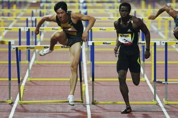 Liu Xiang of China trails Cuban Dayron Robles in the 110m hurdles