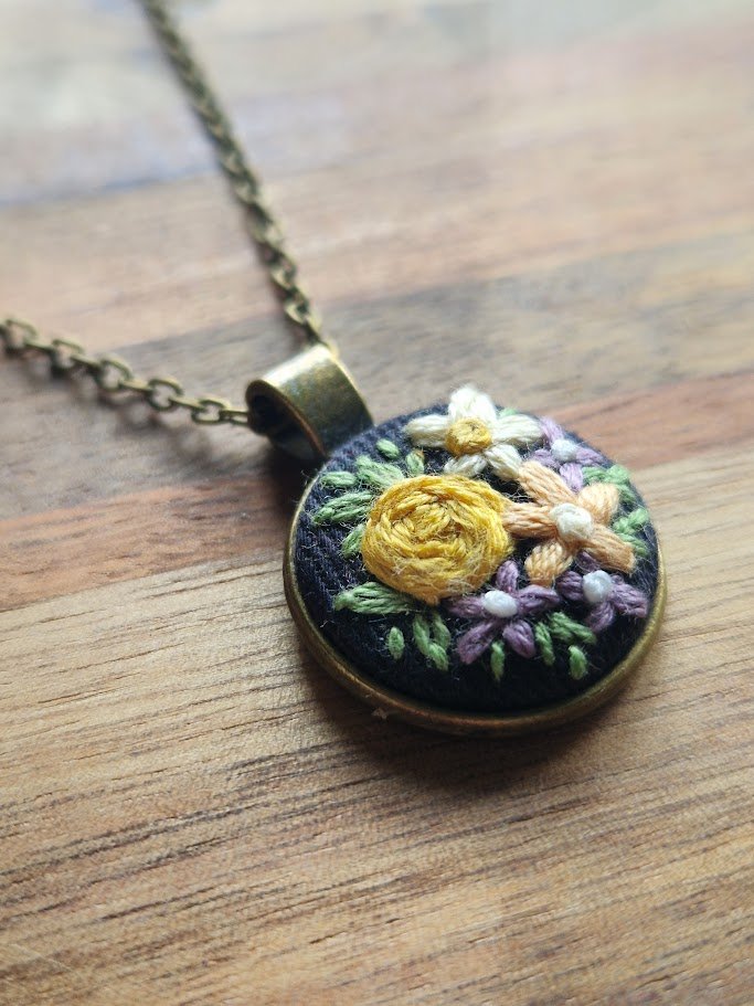 Hand-Embroidered Floral Pendant on Navy Linen