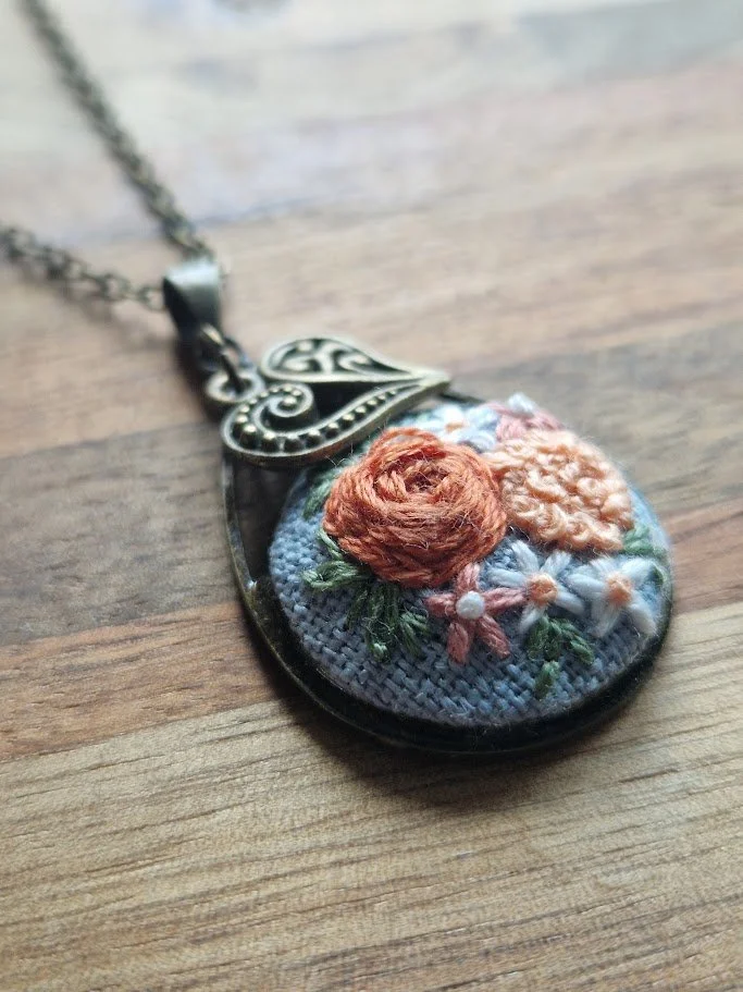 Hand-Embroidered Floral Bronze Pendant with Heart Charm