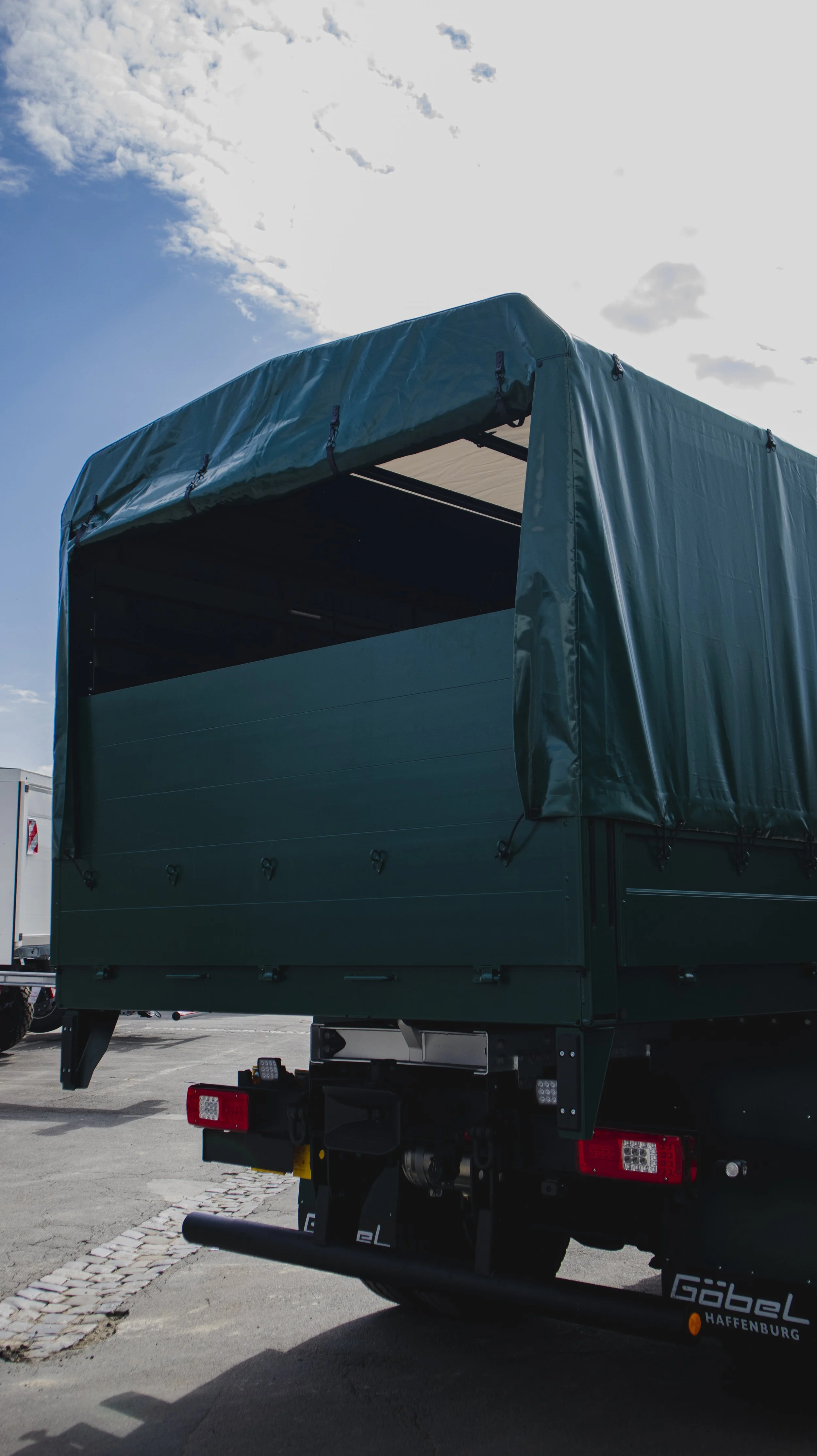Einsatzfahrzeug Defence der Marke Iveco Eurocargo von Göbelfahrzeugbau als Truppentransporter umgebaut mit Pritsche Heckansicht, geschlossen