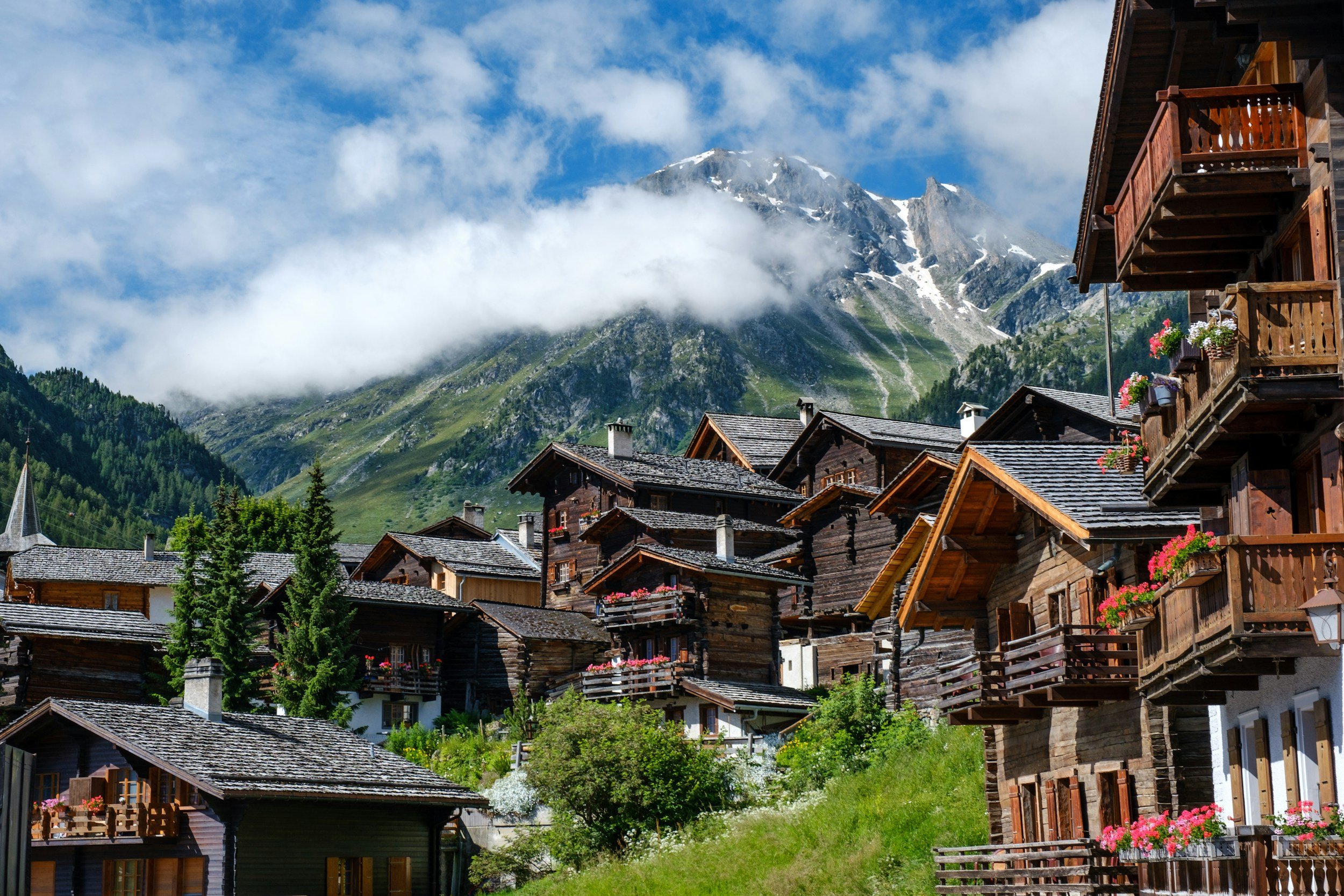 Alpine village with wooden chalets and mountain views in the European Alps