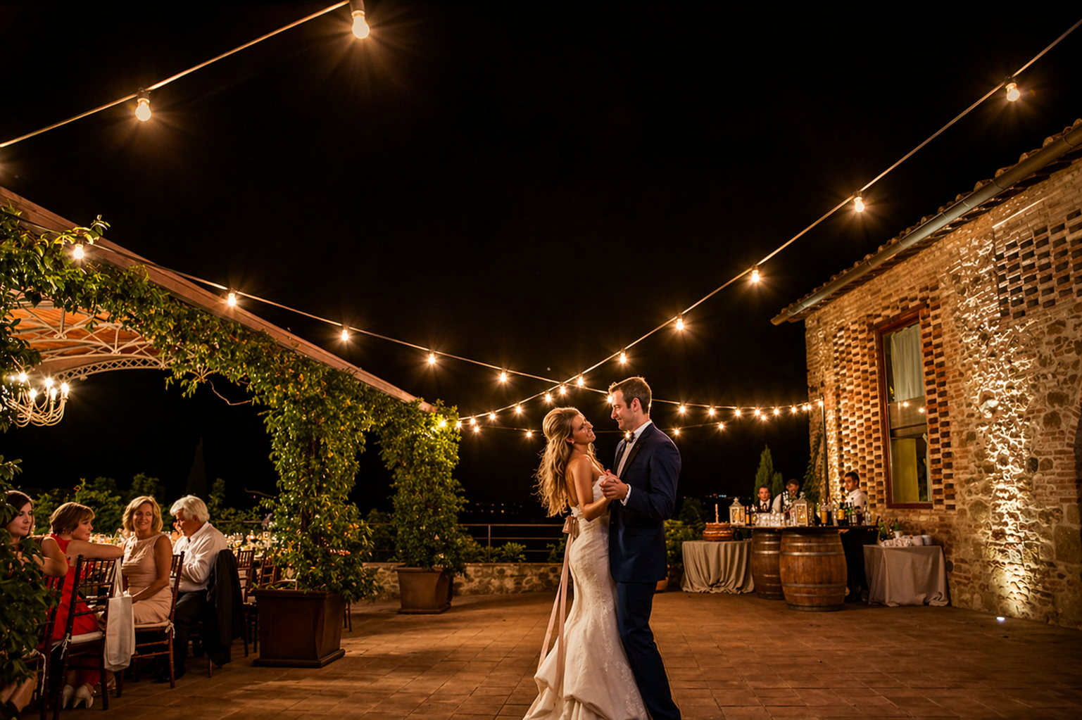 Romantic destination wedding in Italy at night with couple dancing under string lights at a countryside villa