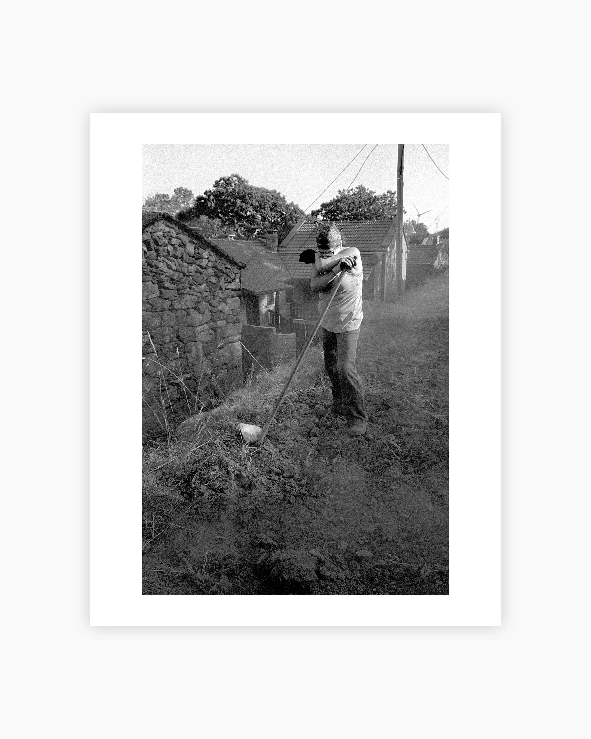 A woman with a hoe after working the land. Mourim, Portugal. 2025.