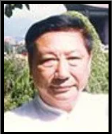Portrait of a man outdoors with greenery in the background
