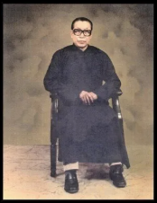 Person seated in a chair wearing traditional attire