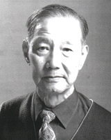 Portrait of an elderly man in a formal outfit with a tie.