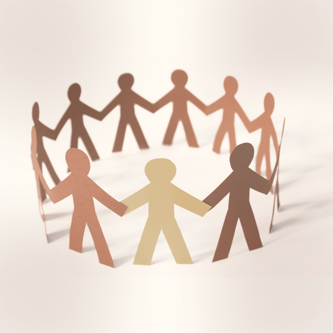 Paper cutout of people holding hands in a circle.