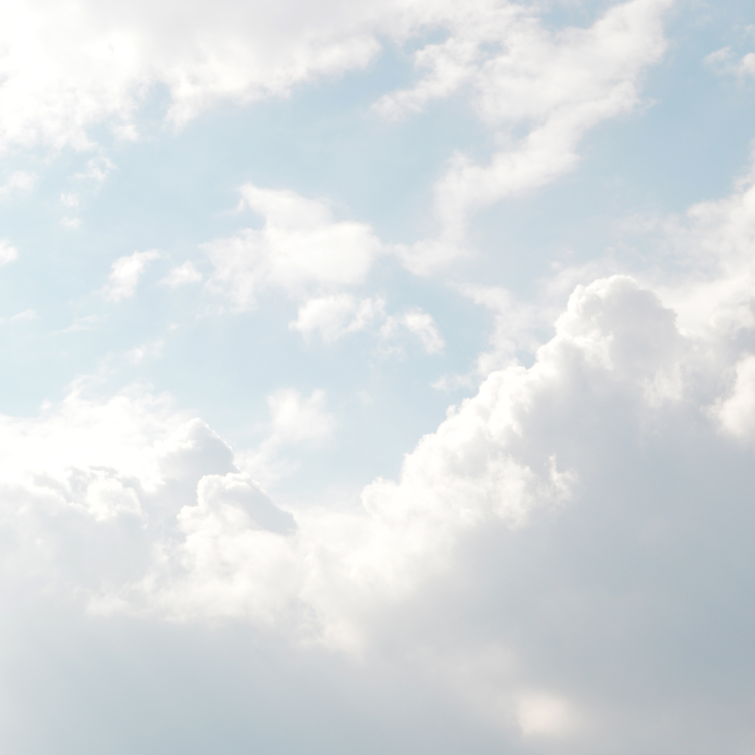 Light blue sky with white, fluffy clouds.