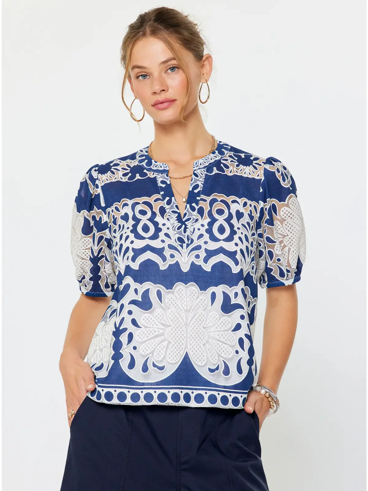 blue and white cut out blouse.webp