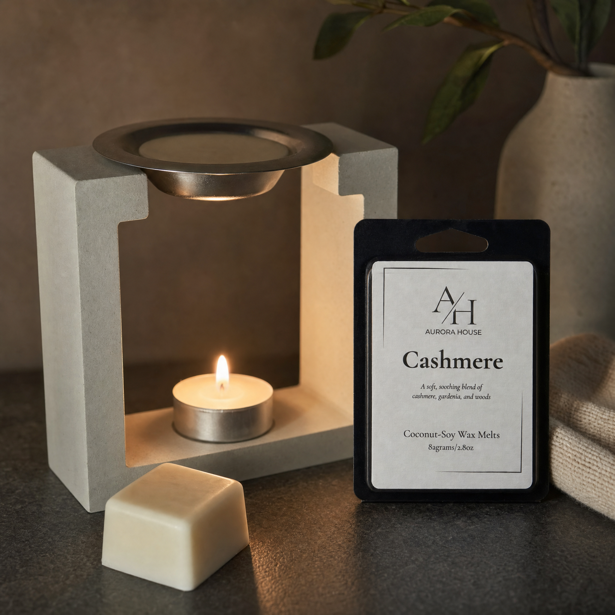 Aurora House wax melts styled beside a modern concrete wax warmer with warm ambient lighting and minimalist decor.