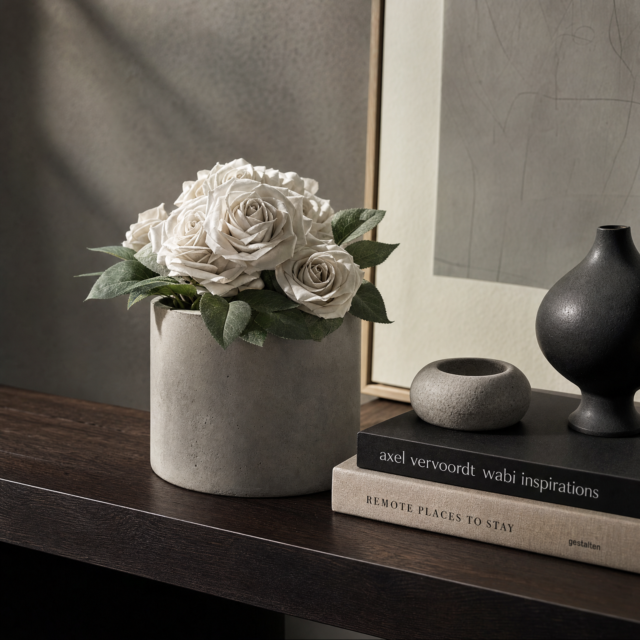 Modern concrete vessel displayed on a dark shelf with architectural decor and soft natural lighting.