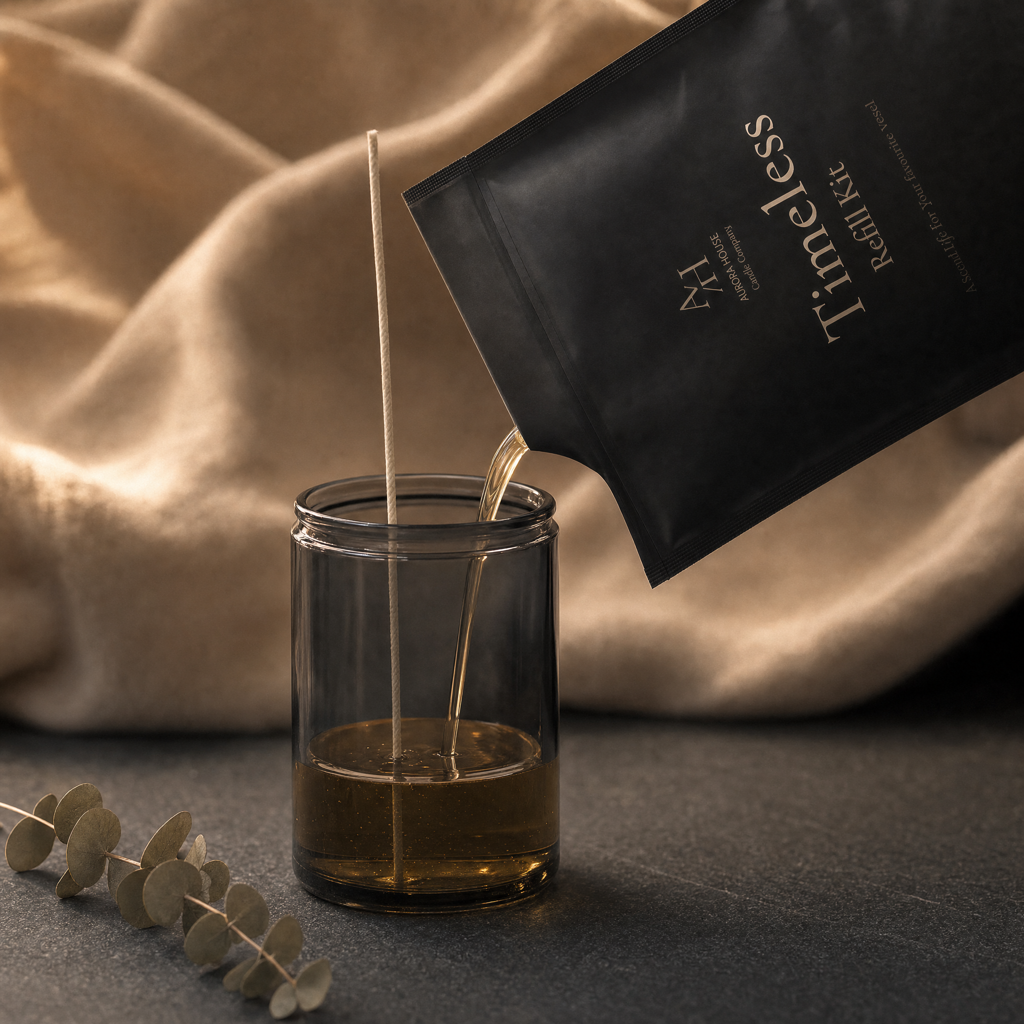 Aurora House candle refill kit being poured into grey glass candle jar