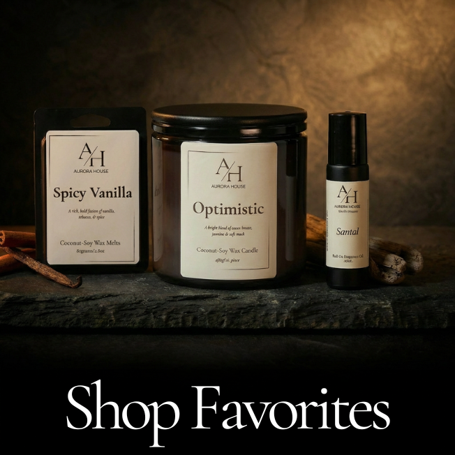 Aurora House 15oz Candle, Wax Melt pack, and body fragrance roller styled on slate tile