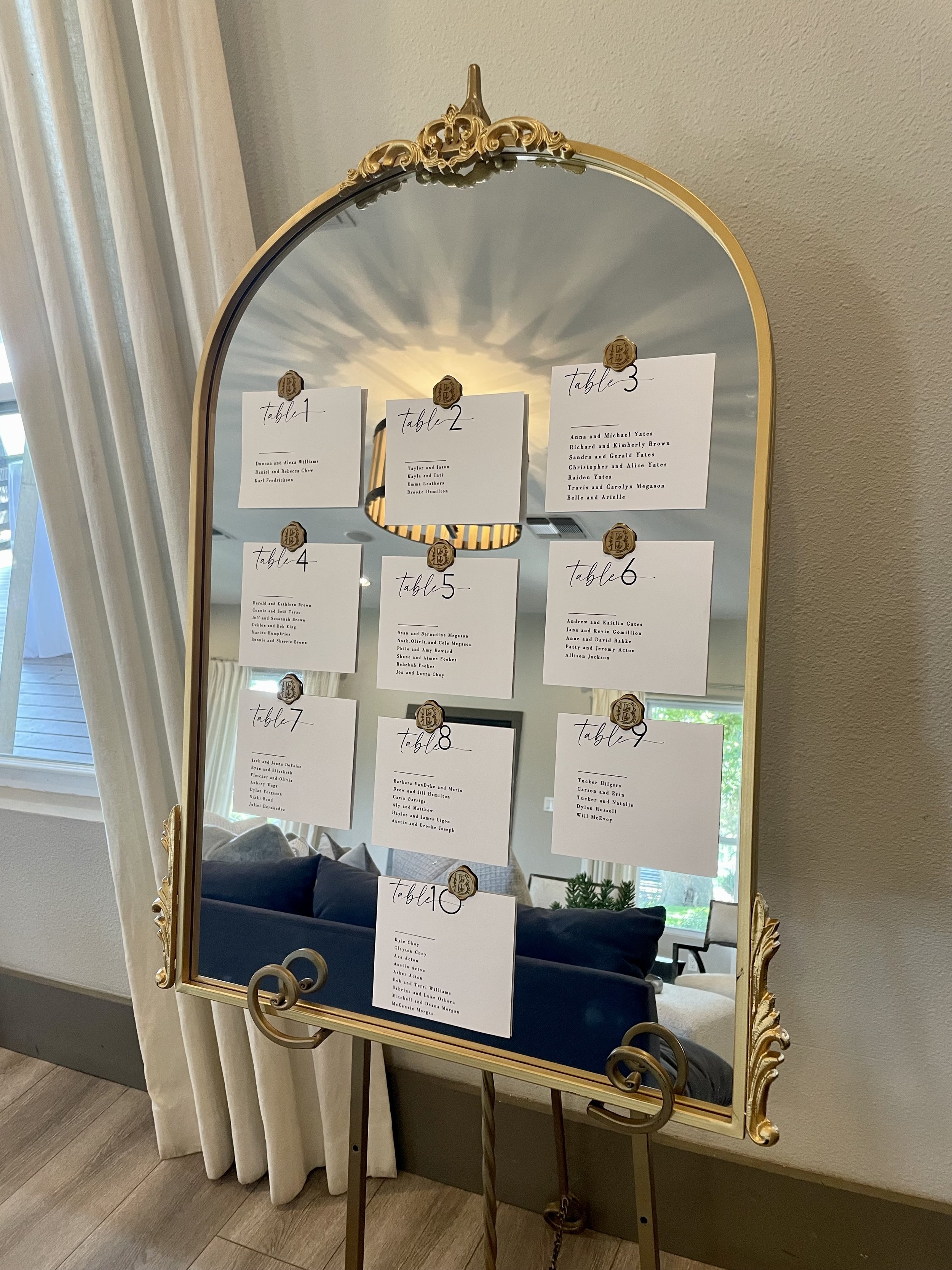 Gold Mirror with guest tables settings held with  Wax Seal