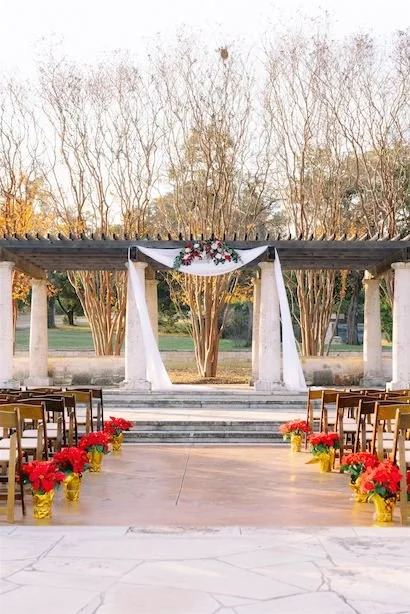 Ceremony Space wit Poinsettias lining the isle