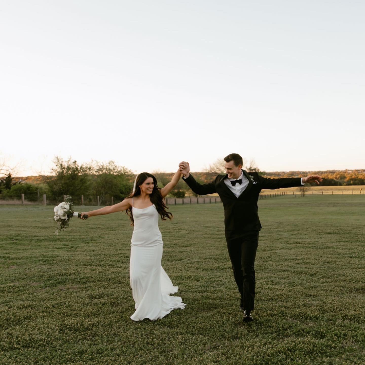 Couple running and celebrating in a field at Garey House in Georgetown Texas