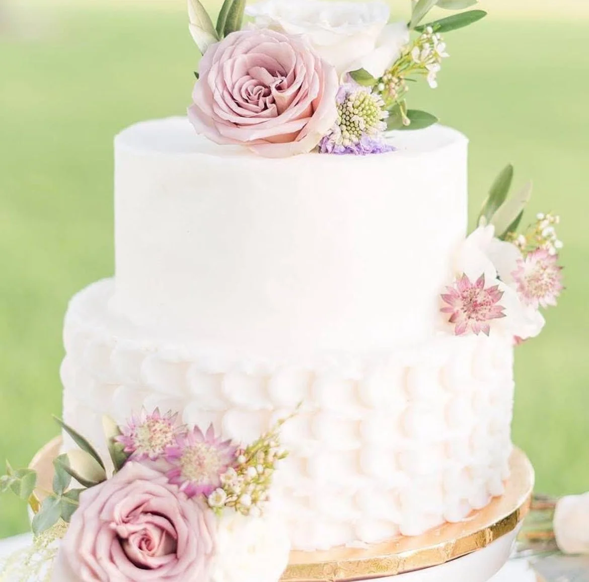 Small two tier wedding cake with simple floral decor