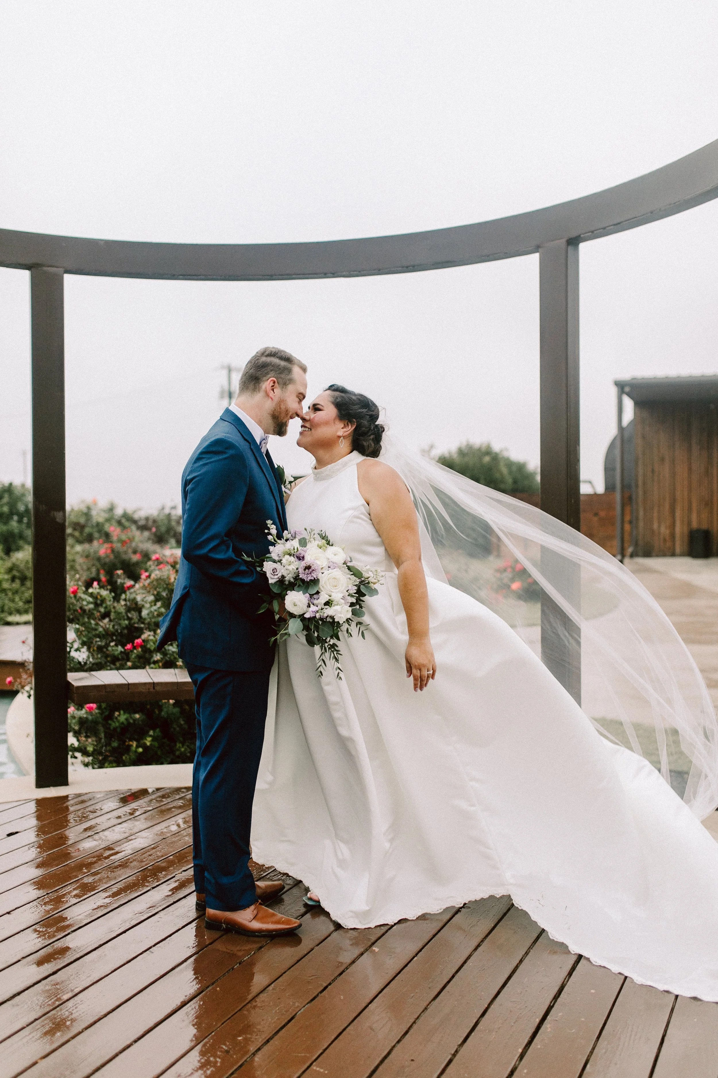 Couple posing in the rain at Celebrino event center