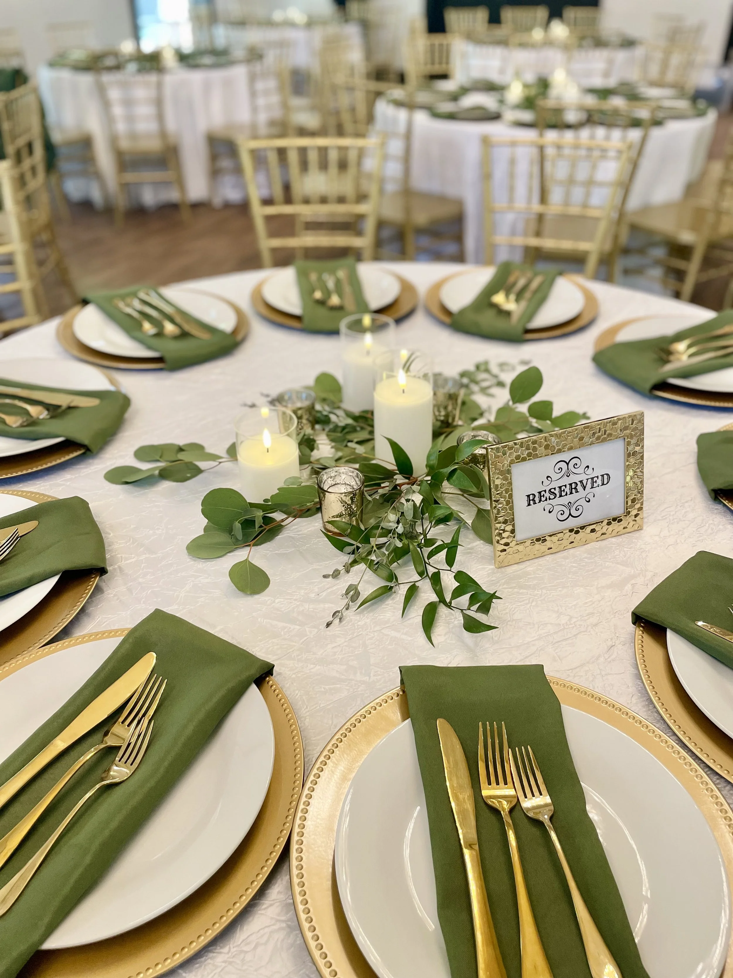 Green and Gold Reception decor with greenery and candles centerpieces