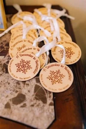 Wooden Snowflake Ornaments as personalized weddng favors to have at a Christmas inspired wedding