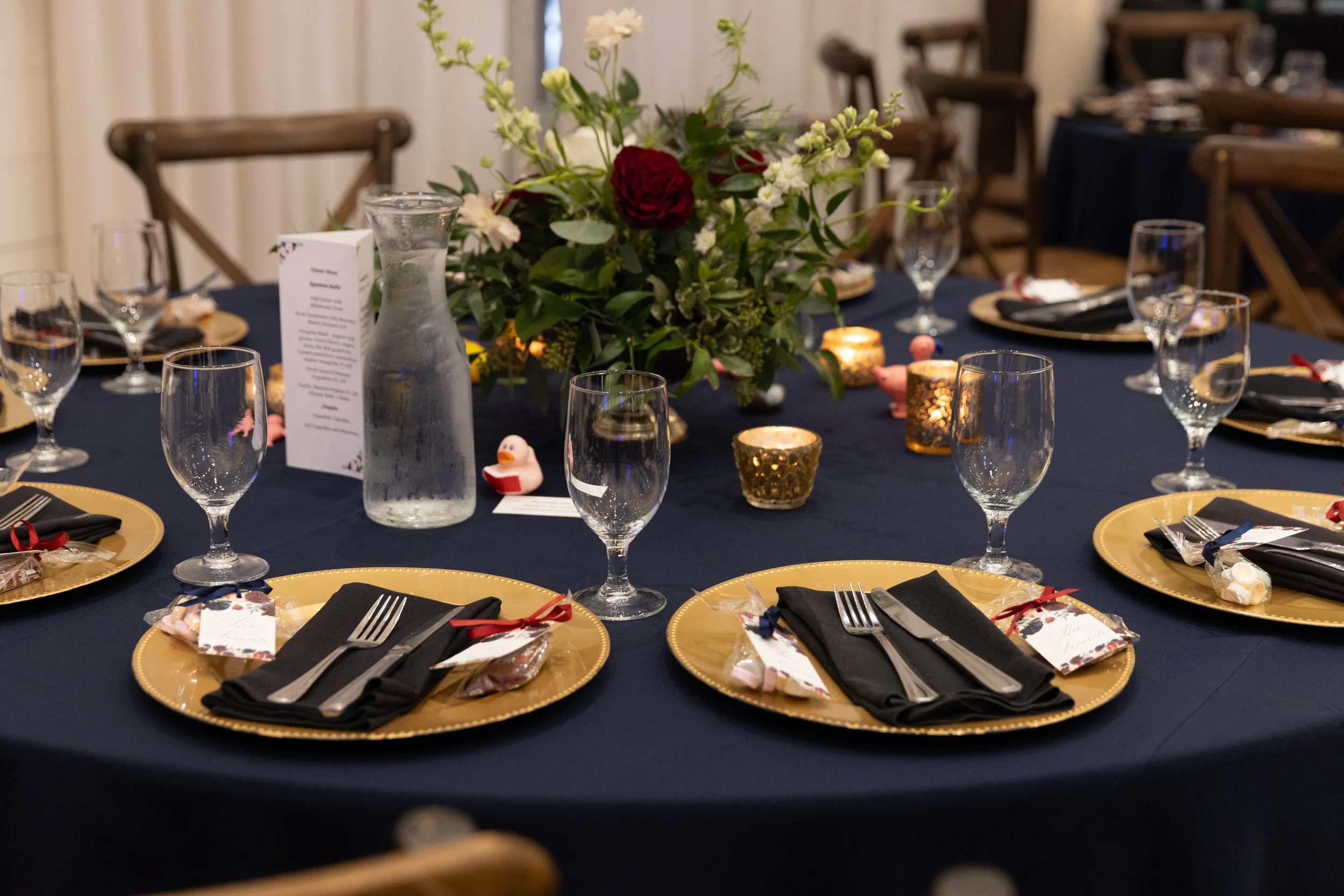 Navy linens with gold chargers and black napkins for reception tables at HighPointe Estate