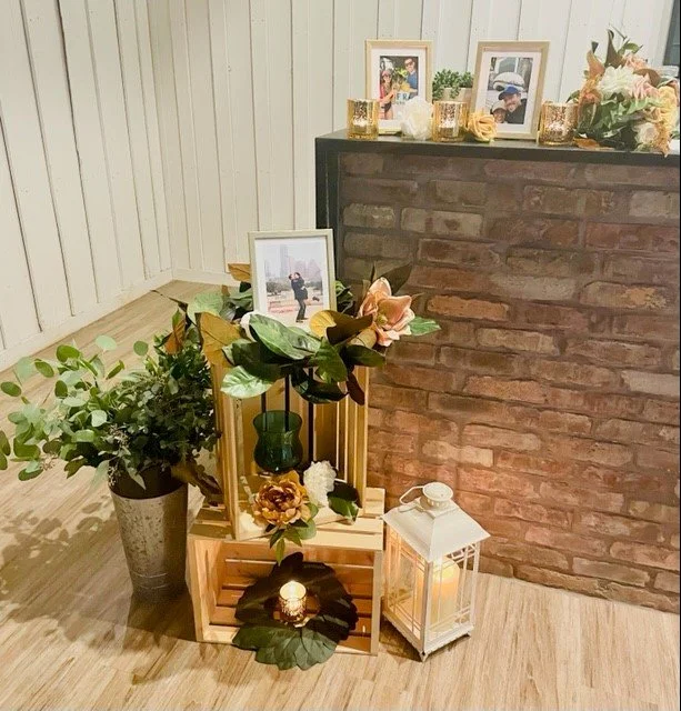 Crate and orange floral decor placed at a bar at The Milestone Venue in Georgetown Texas