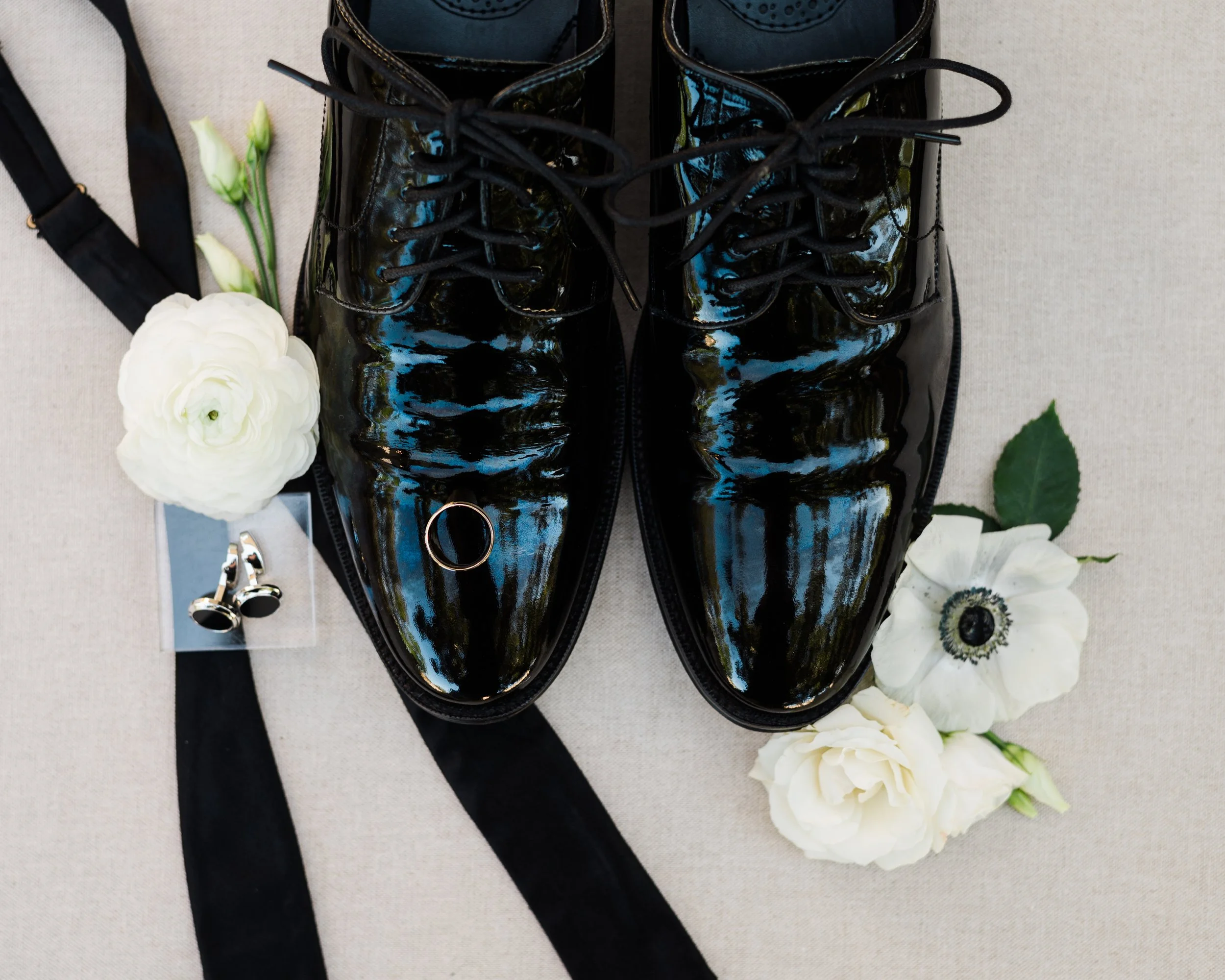Grooms details with suspenders