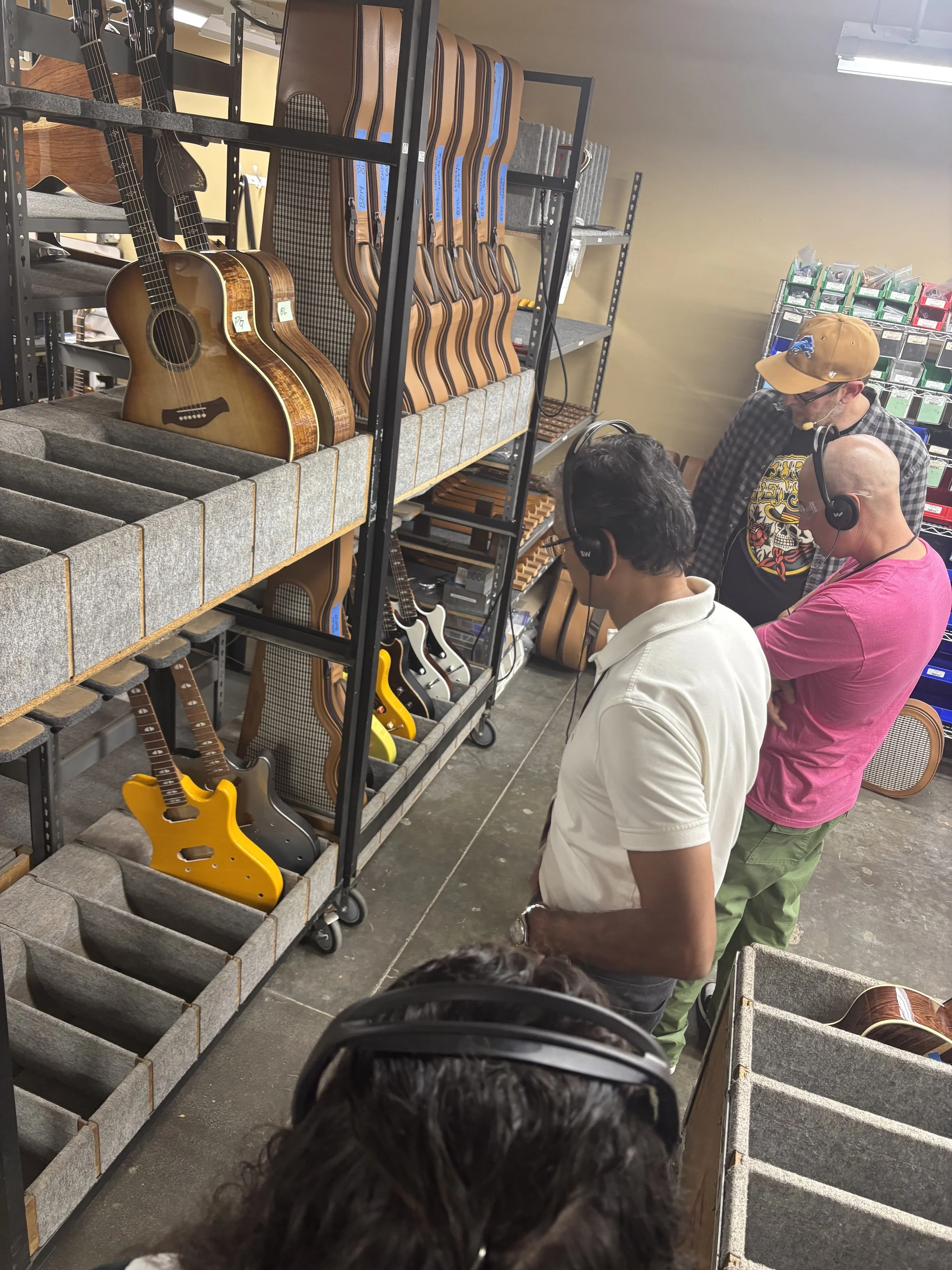 A person walking along a coastal path at sunset, carrying a bag, with seagulls flying in the sky and clouds.
