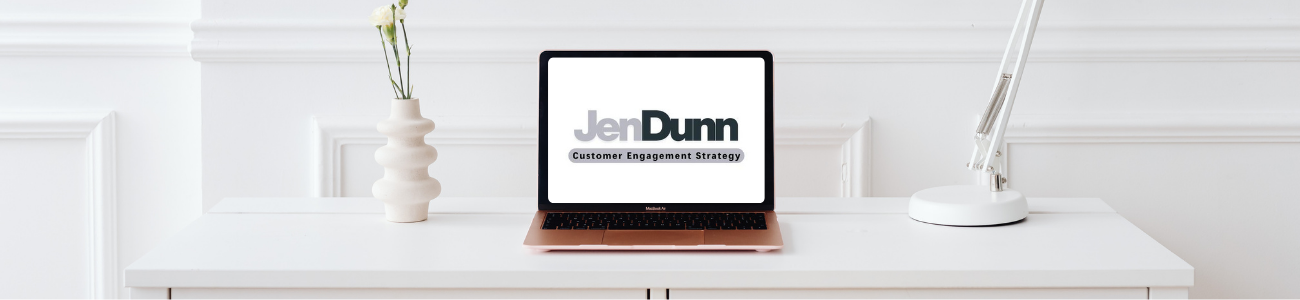 White, modern office, laptop with screen showing: Jen Dunn Customer Engagement Strategy