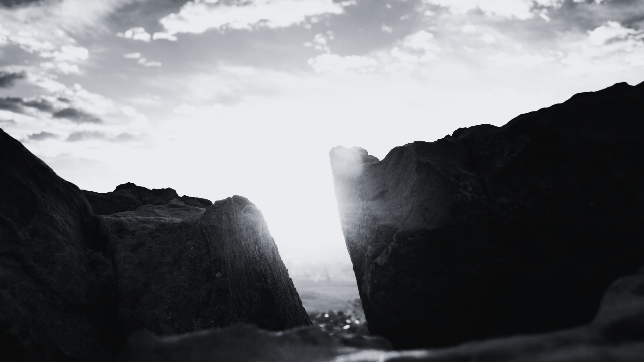 The space between two cliffs with light shining through the gap