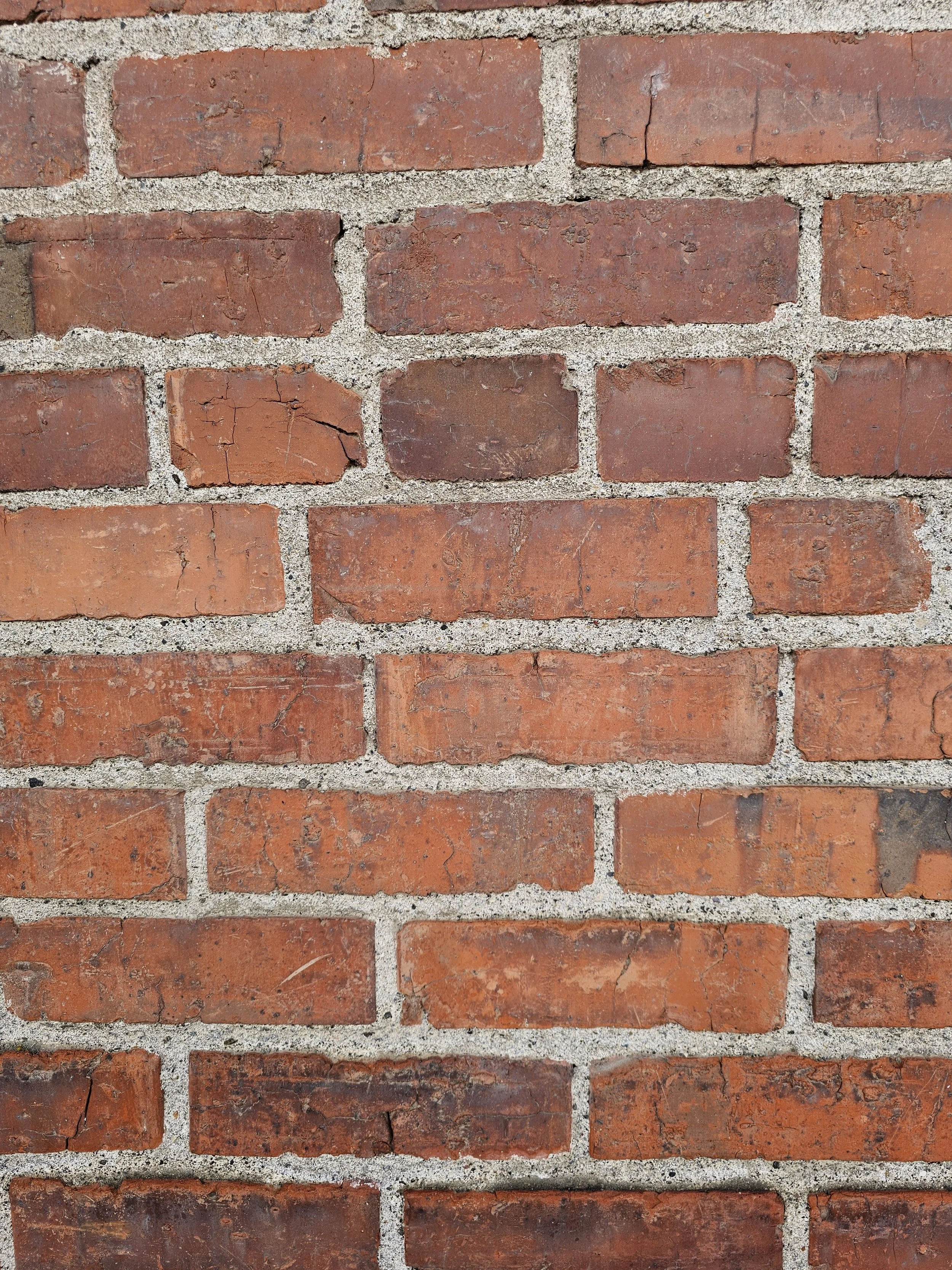 A close-up view of a red brick wall with mortar joints.