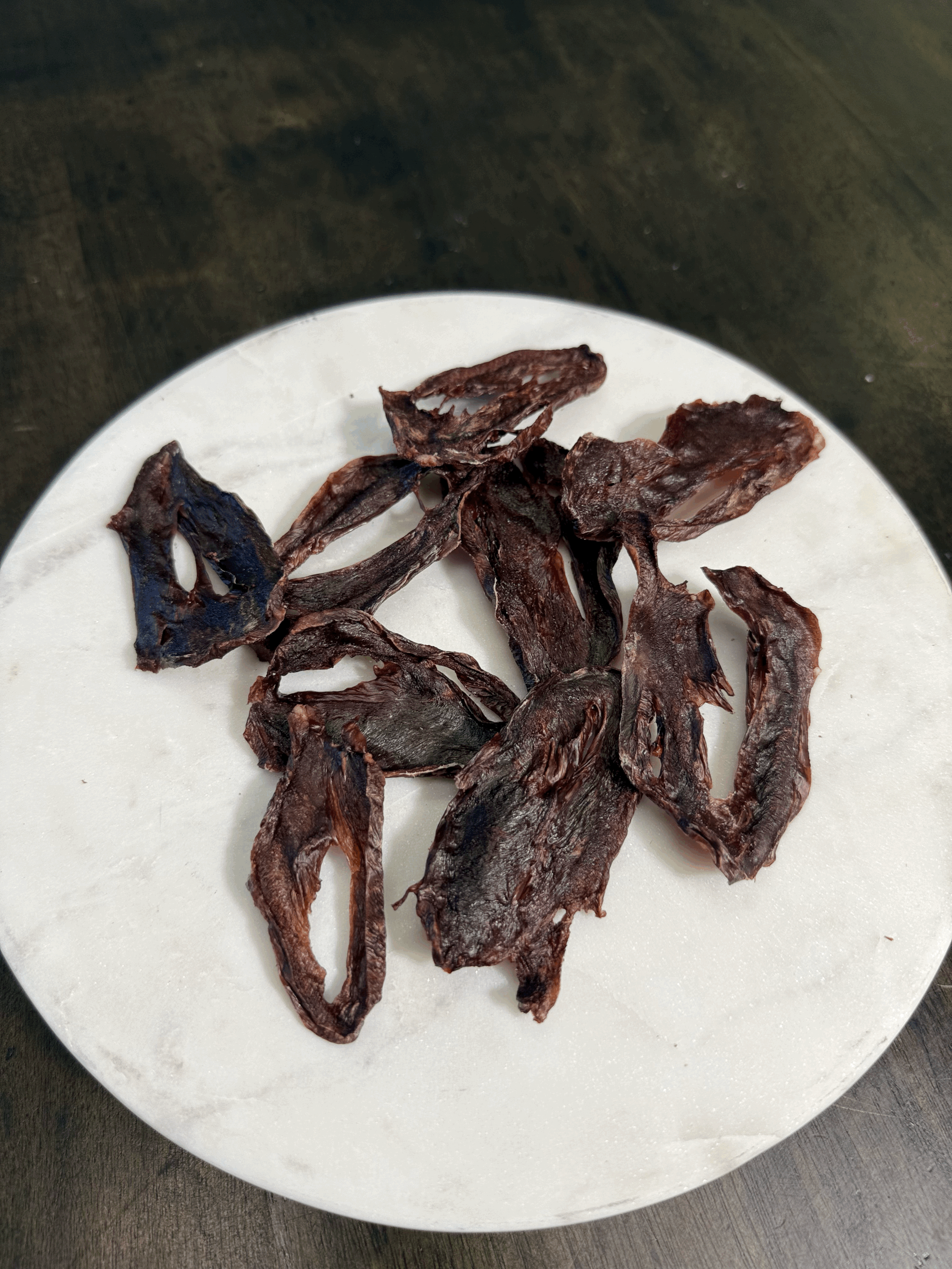 Air-dried goat heart pieces showing natural texture and rich brown color.