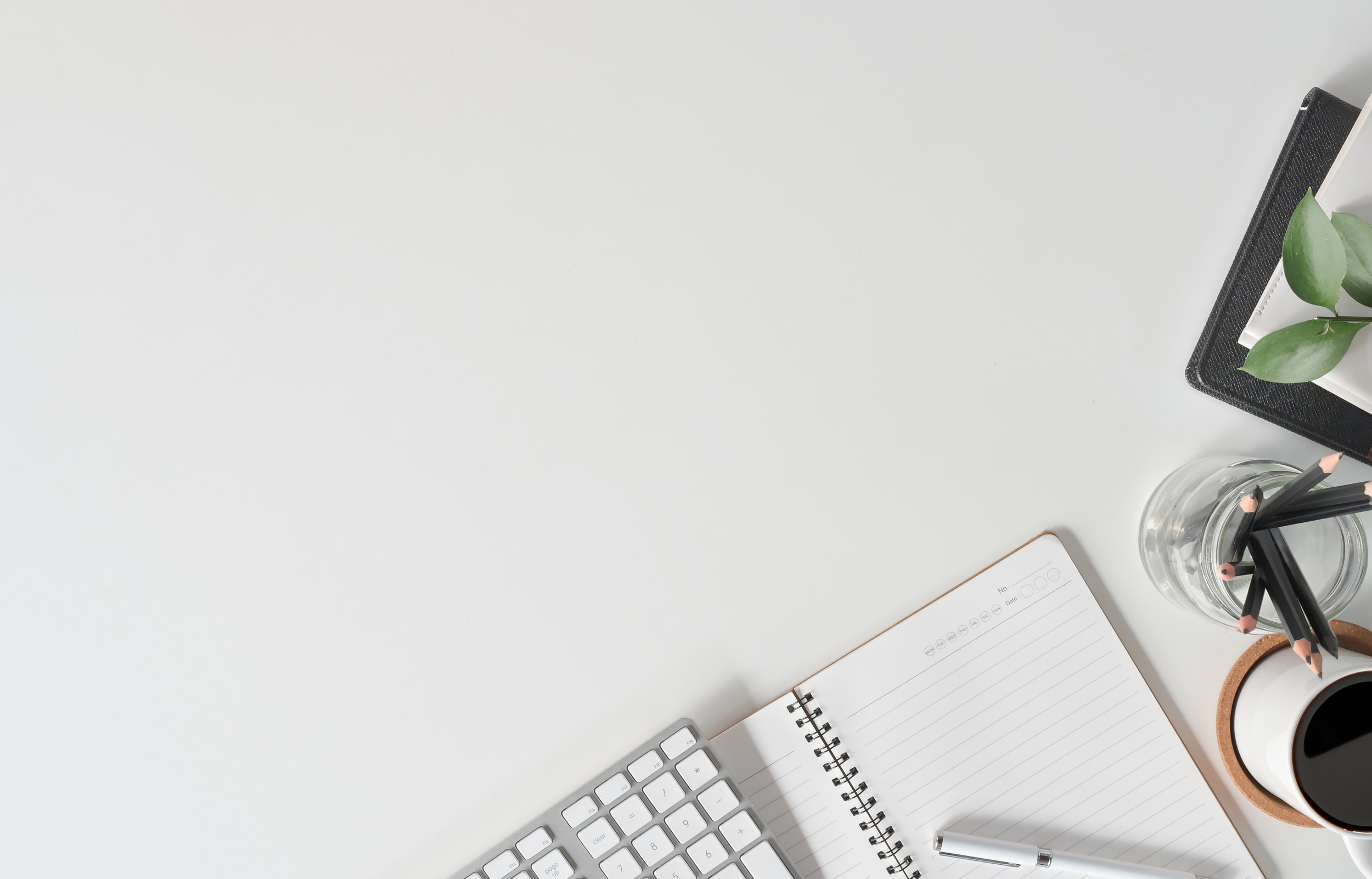 white computer desk with open notebook