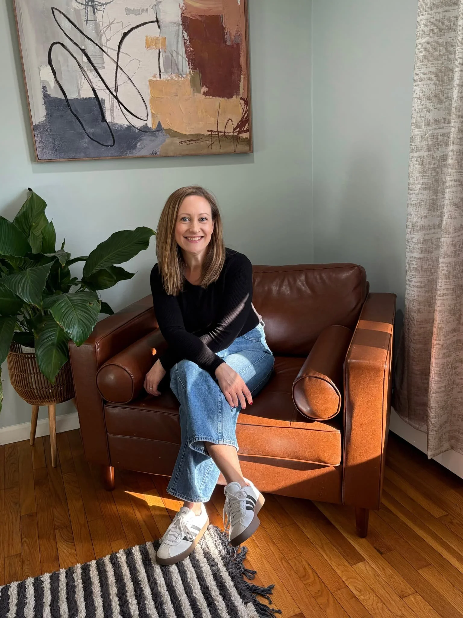 Megan Clause sitting on leather chair