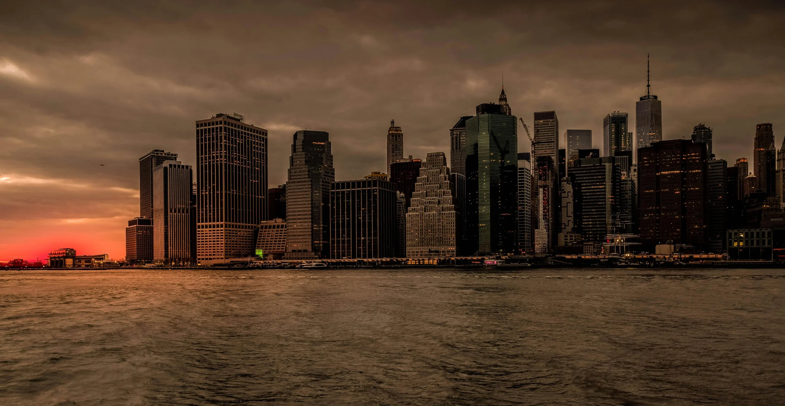 New York City skyline at sunset with dark clouds